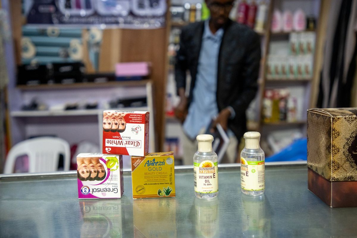 A young shop owner at his counter