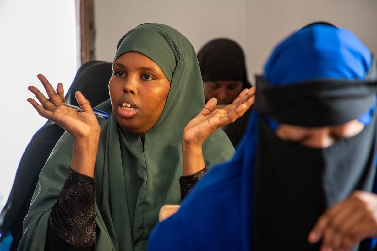 A woman asking a question in class