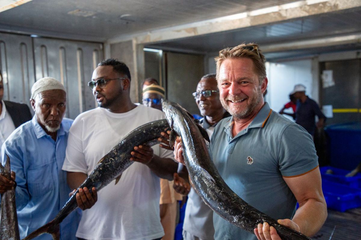 Partners holding fresh fish in Berbera