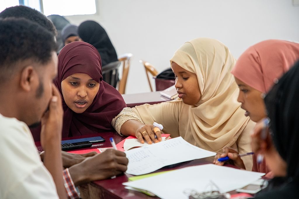 Young women working together in class