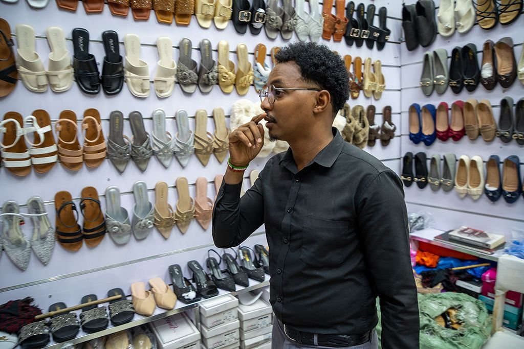 A young man at work in a shoe shop