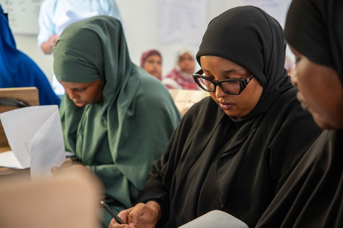 Two women discussing in class