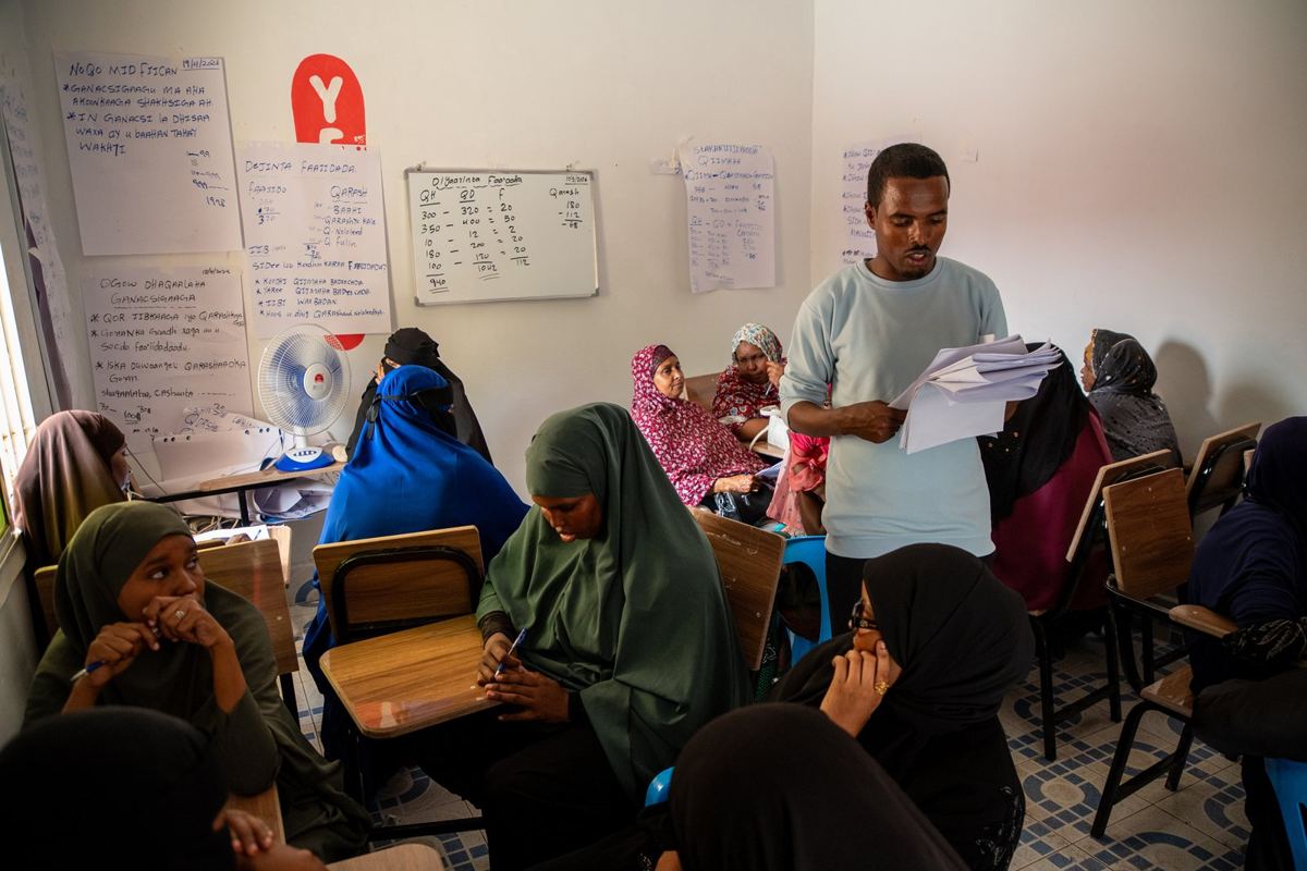 A trainer teaching a class of women in Burao
