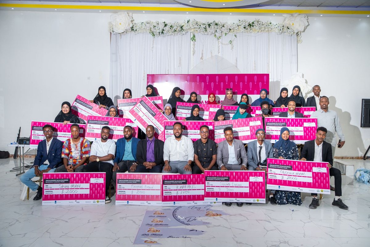 Graduates holding their seed funding awards