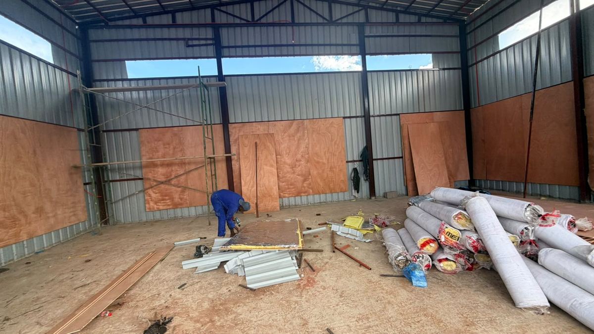 Workers fitting insulation panels inside the hub