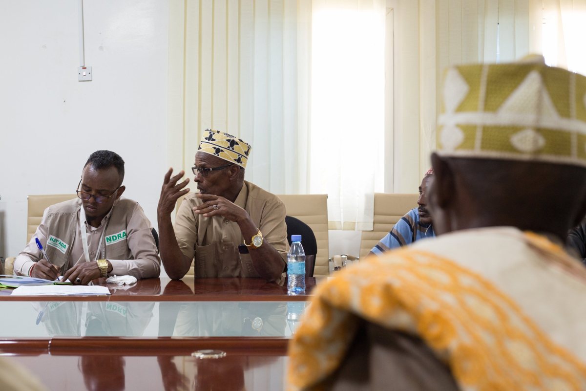 A community elder speaking at a meeting with the national refugee agency