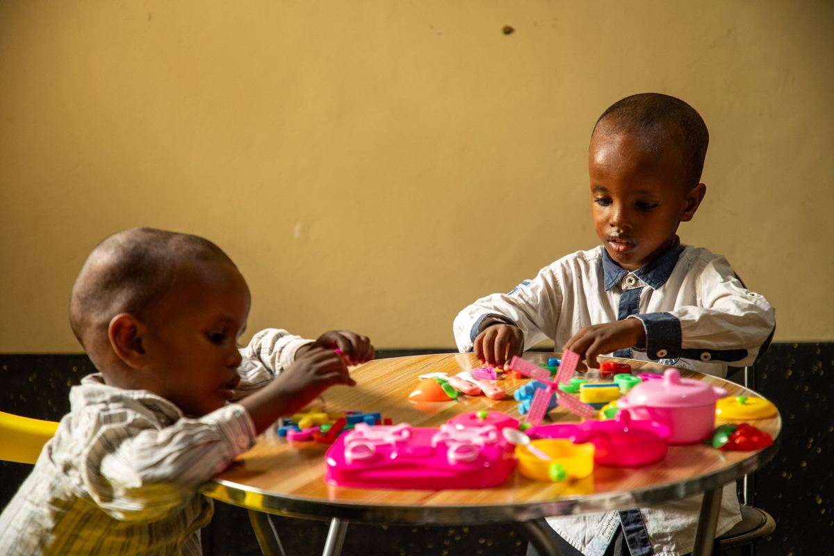 Two children playing in the childcare room