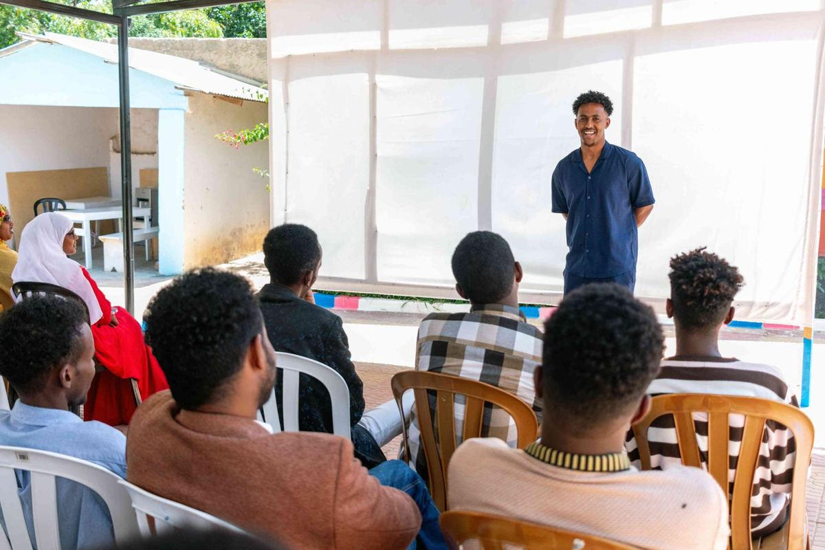Young people listening to a guest speaker at YEEL