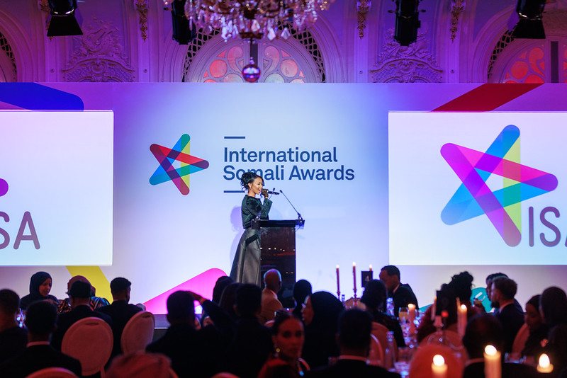 A presenter on stage in front of the guests