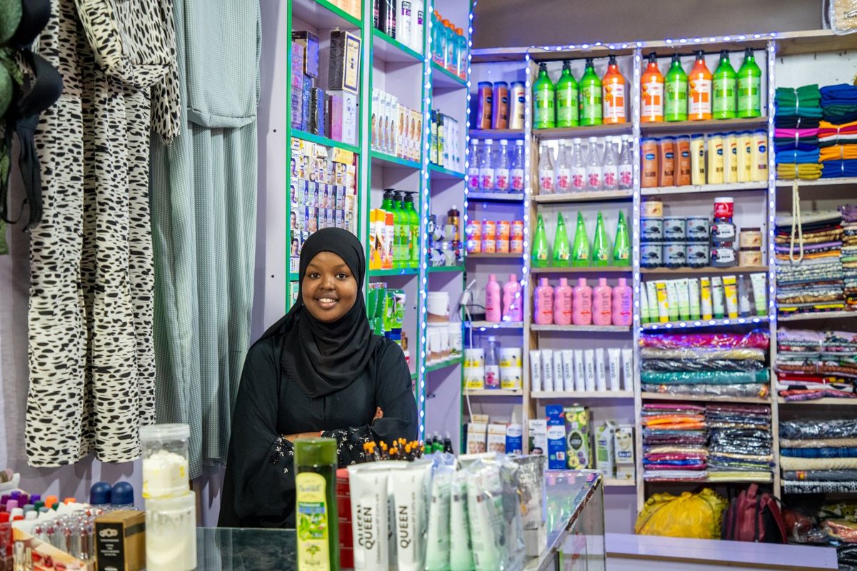 A young woman at the counter of her shop