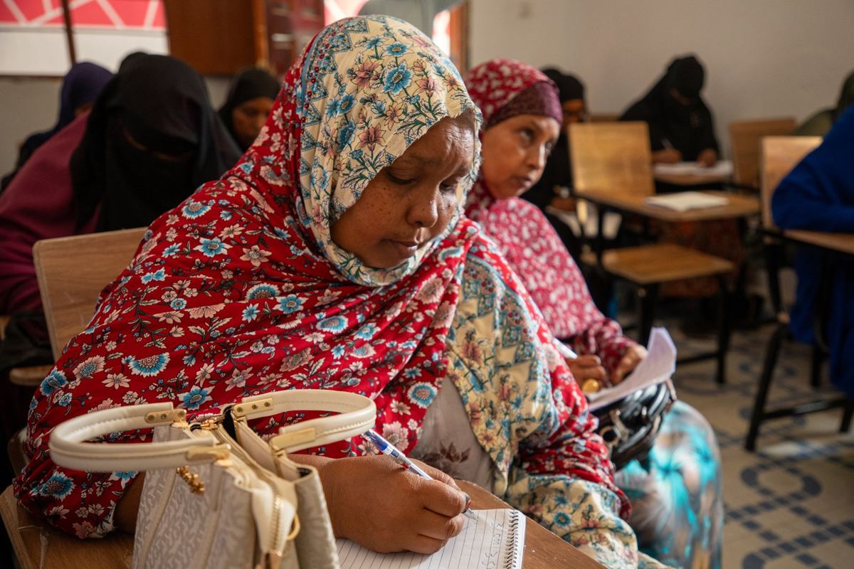A participant writing in her notebook