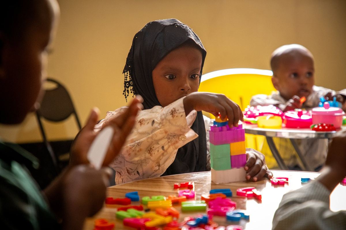 Children playing in the childcare room while their mothers train